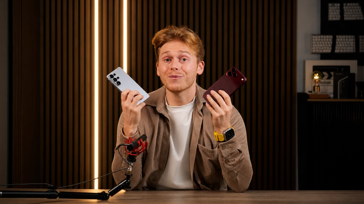 Alex Caulfield holding two phones while filming a Tech It Easy video