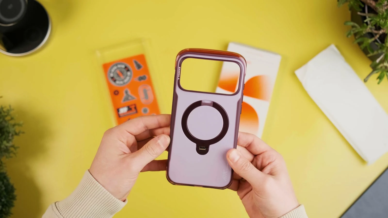 TORRAS Q3 Air Pro case being demonstrated on a yellow tabletop